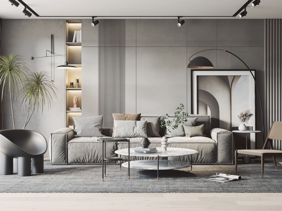 The image shows a modern living room with a gray and white color scheme. The room features a gray couch with white and gray patterned pillows, a